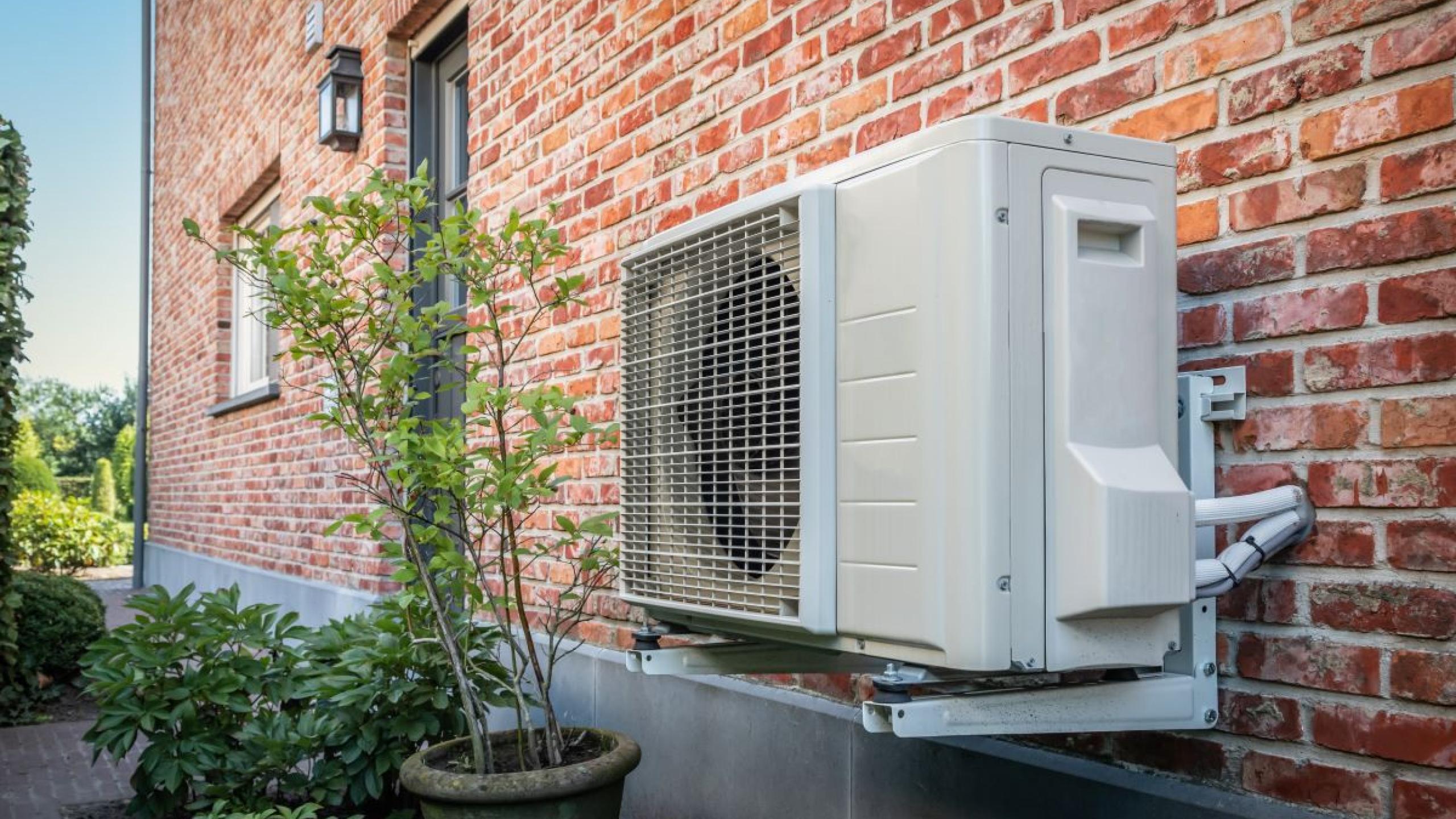 Warmtepomp tegen bakstenen muur